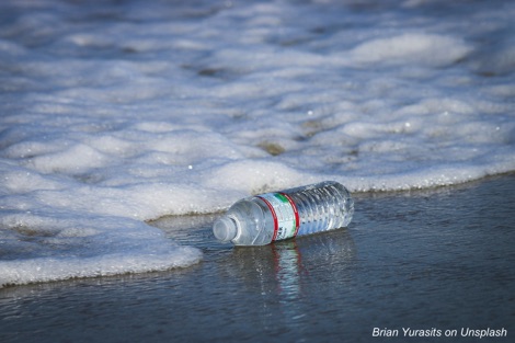 Discarded plastic water bottle on a beach